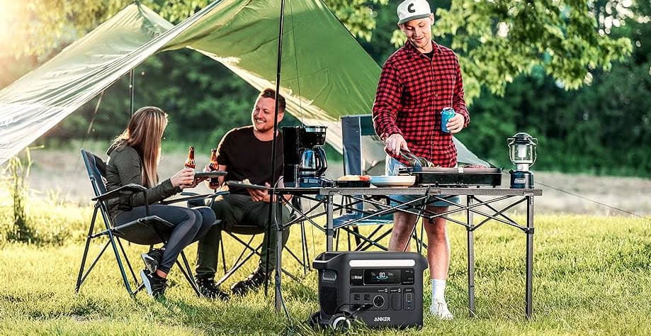 Anker F2600 power station providing energy for cooking and lighting during an outdoor camping setup, supplied by UPS Equip.