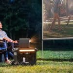Anker F2600 power station powering an outdoor movie night with a projector, supplied by UPS Equip.
