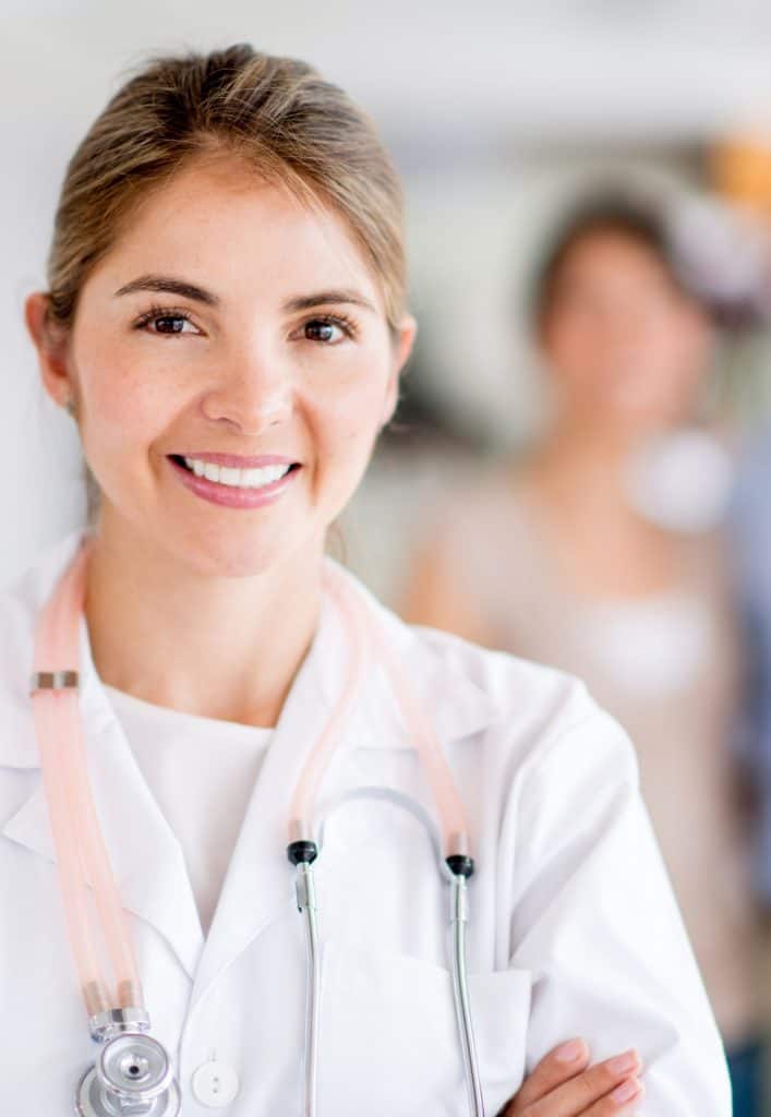 Smiling healthcare professional ensuring vaccine storage reliability for patient safety.