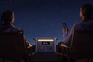 Camping scene at night with Anker battery pack charging devices under the stars