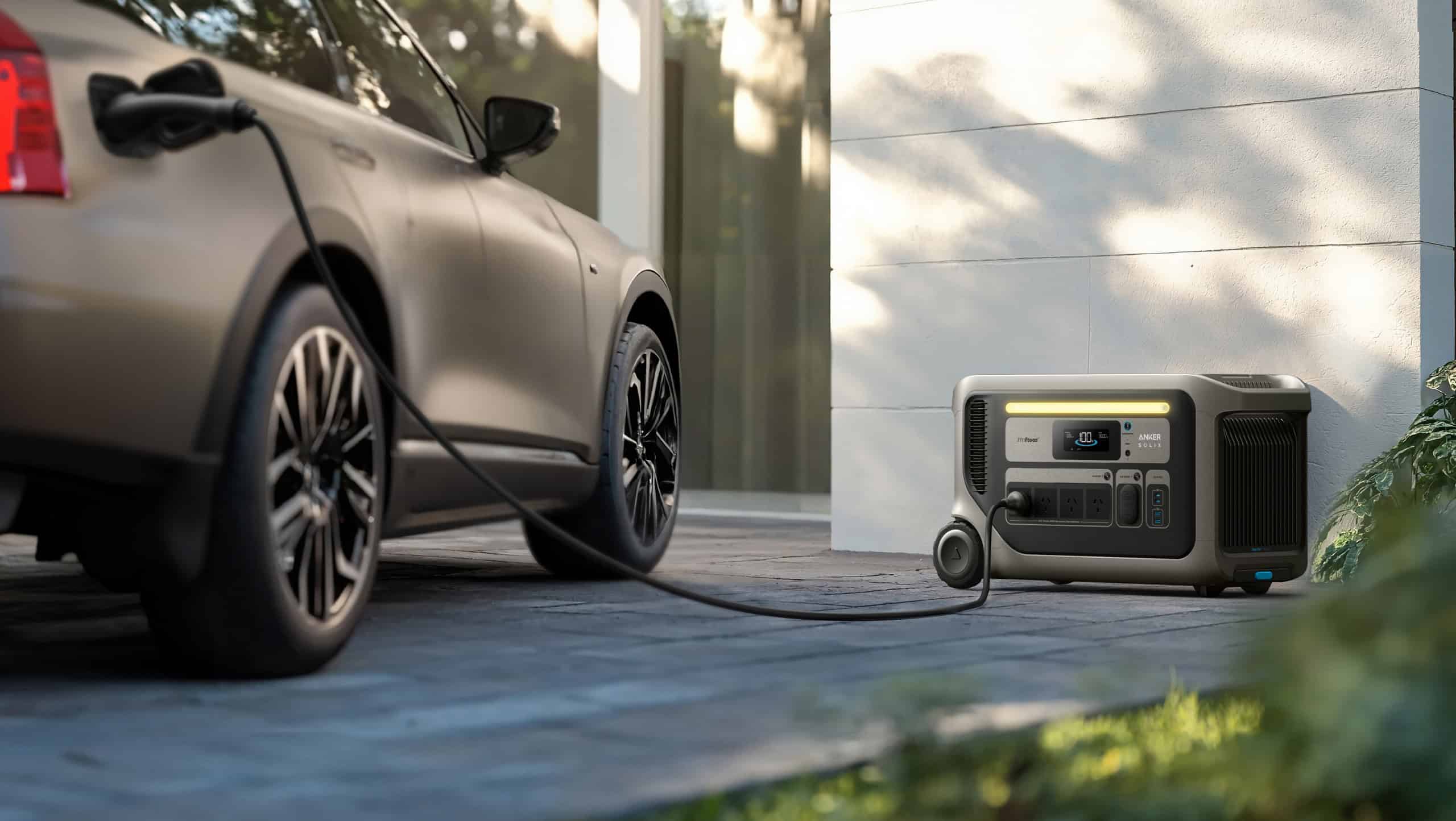 Showing the Anker SOLIX F3000 portable power station connected to an electric vehicle, providing emergency EV charging outside a modern home.